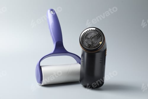 Preview: Lint roller and fabric shaver on light grey background, closeup