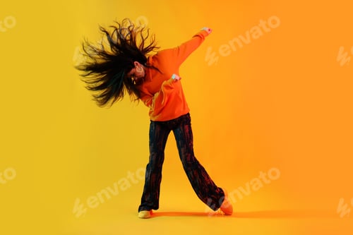 Preview: Young woman performing hip-hop dance on color background