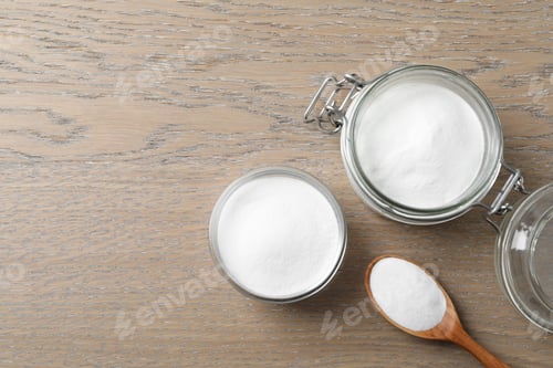 Preview: Baking soda on wooden table, flat lay. Space for text
