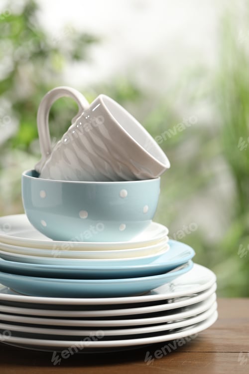 Preview: Beautiful ceramic dishware and cup on wooden table outdoors