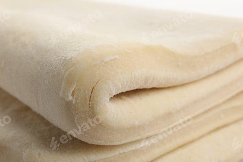 Preview: Raw puff pastry dough as background, closeup