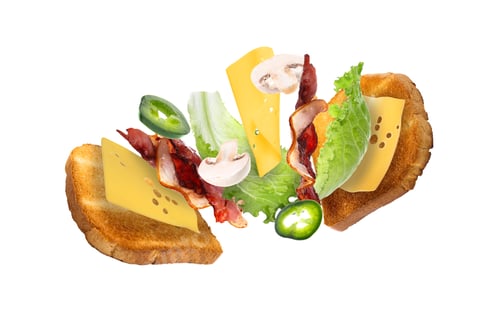 Preview: Toasted bread slices and sandwich ingredients flying in air against white background