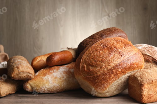 Preview: Different types of bread on wooden table, closeup