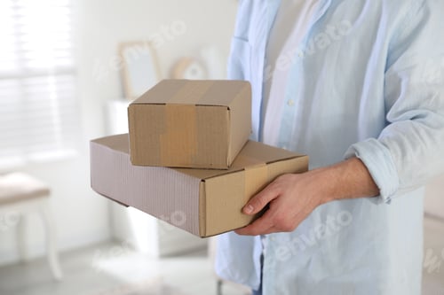 Preview: Parcel delivery. Courier giving cardboard boxes at home, closeup