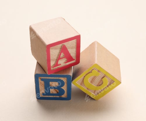 Preview: Wooden cubes with letters on beige background, closeup
