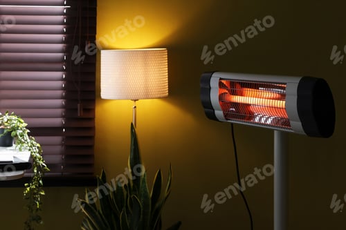 Preview: Electric heater, lamp and houseplants indoors, closeup