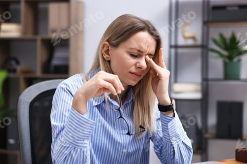 Preview: Unhappy woman feeling extreme fatigue in office