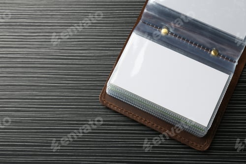 Preview: Leather business card holder with blank cards on grey table, top view. Space for text