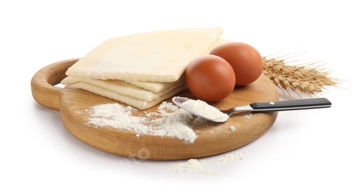 Preview: Raw puff pastry dough, flour, eggs and spikes isolated on white