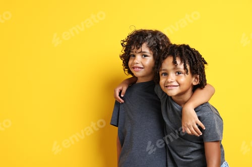Preview: Portrait of cute brothers on yellow background, space for text