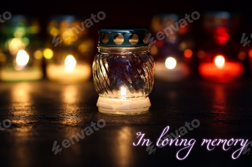 Preview: In loving memory. Many different grave lights on table in darkness