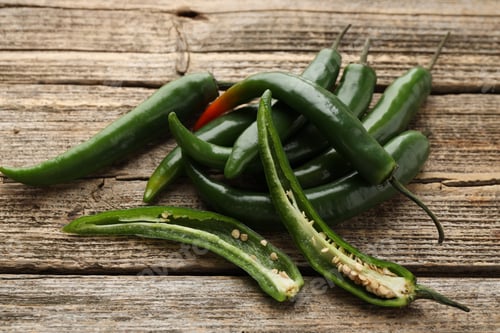 Preview: Fresh green chili peppers on wooden table, closeup