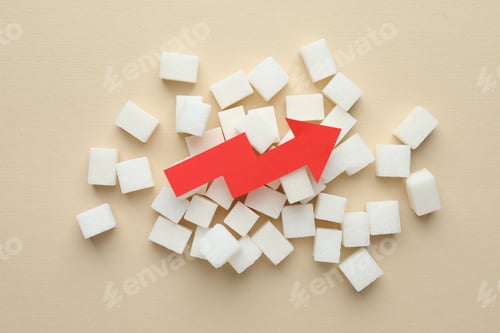 Preview: Diabetes control. Pile of sugar cubes with arrow showing high blood sugar level on beige background,