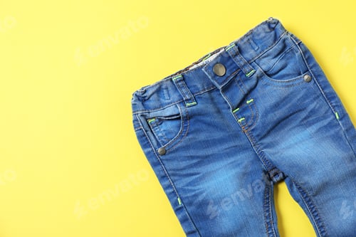 Preview: Baby pants on yellow background, top view. Space for text