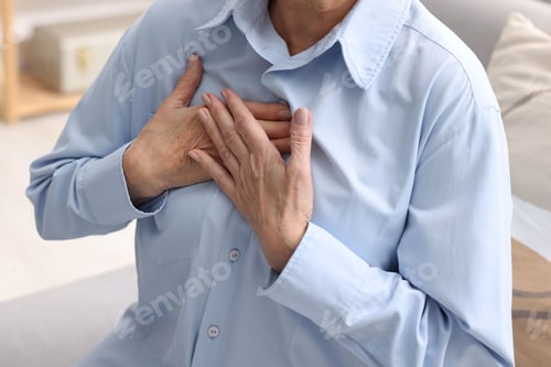 Preview: Heart attack. Senior woman suffering from pain in chest indoors, closeup