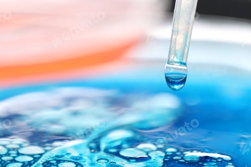 Preview: Dripping liquid from pipette on light background, closeup