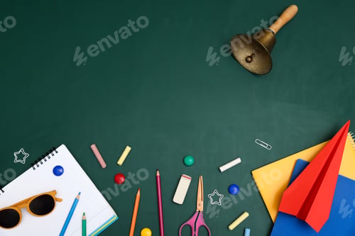 Preview: School holidays. Sunglasses, paper plane, golden bell and stationery on green background, flat lay.