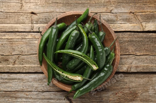 Preview: Fresh green chili peppers on wooden table, top view