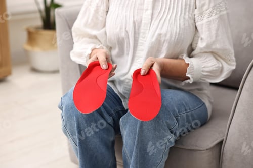 Preview: Woman with orthopedic insoles at home, closeup