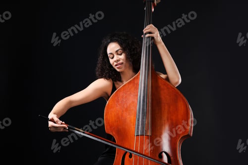 Preview: Woman playing double bass on black background