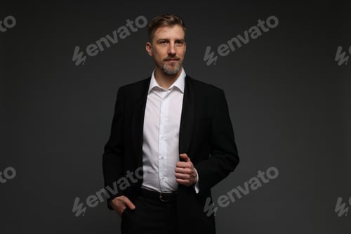 Preview: Handsome man in suit on grey background