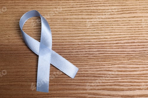 Preview: International Psoriasis Day. Ribbon as symbol of support on wooden table, top view. Space for text