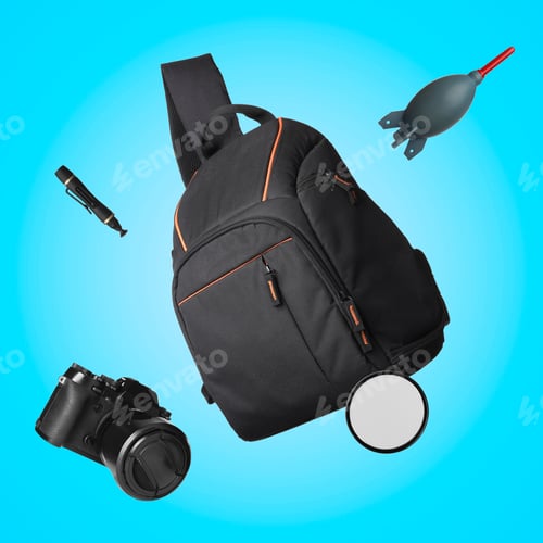 Preview: Photographer's backpack and professional equipment flying against light blue background