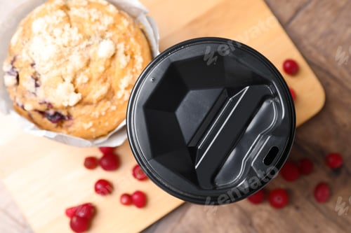 Preview: Tasty muffin, coffee in takeaway cup and cranberries on wooden table, flat lay