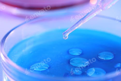 Preview: Dripping liquid sample into Petri dish on light background, closeup