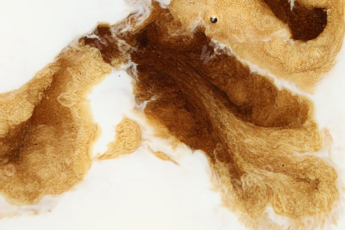Preview: Tasty coffee with milk as background, top view