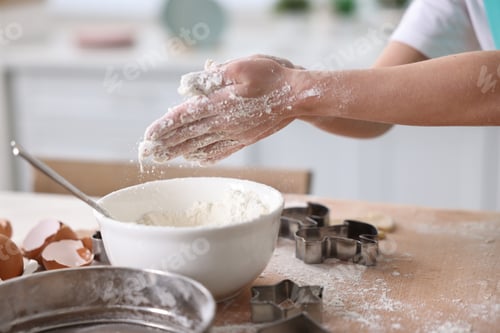 Preview: Child making dough at table indoors, closeup