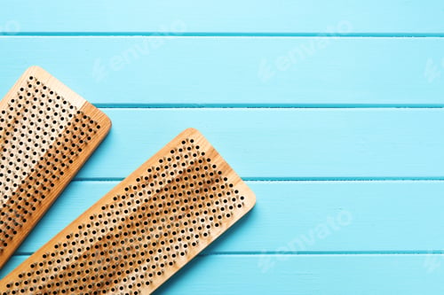 Preview: Nail standing practice. Sadhu boards on light blue wooden background, flat lay. Space for text