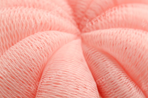 Preview: Pink mesh sponge as background, closeup. Shower accessory