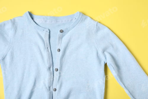 Preview: Baby clothes on yellow background, top view