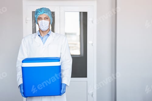 Preview: Laboratory worker holding blue cool box in clinic, space for text