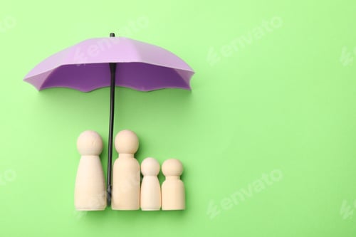 Preview: Small umbrella and family figures on green background, flat lay. Space for text