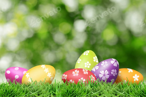 Preview: Easter eggs in green grass against blurred background