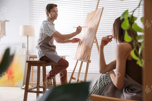 Preview: Romantic date. Couple having painting class in studio