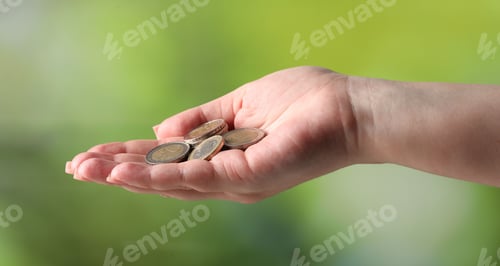 Preview: Woman with coins on blurred background, closeup