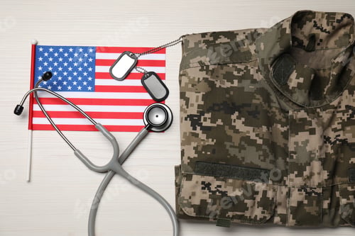 Preview: Stethoscope, USA flag, tags and military uniform on white wooden table, flat lay