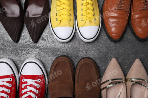Preview: Different beautiful shoes on grey textured floor, flat lay. Space for text