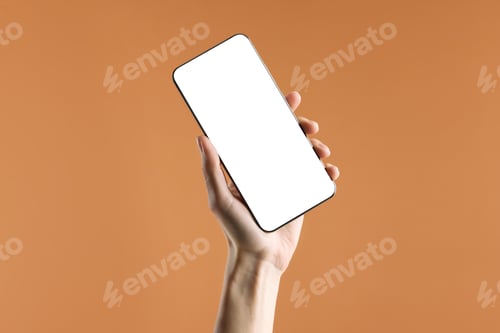 Preview: Woman holding smartphone on orange background, closeup. Mockup for design