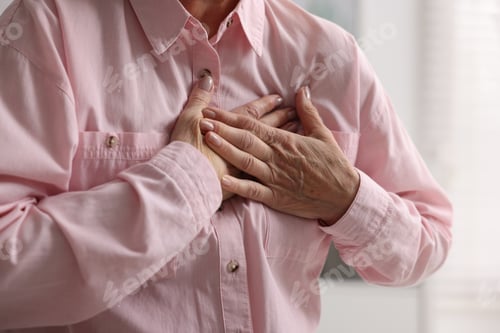 Preview: Heart attack. Senior woman suffering from pain in chest indoors, closeup