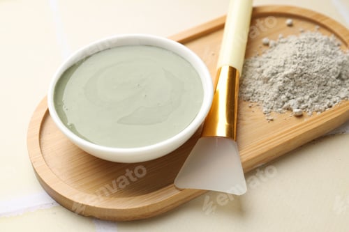 Preview: Clay powder, paste and brush on beige tiled background, closeup