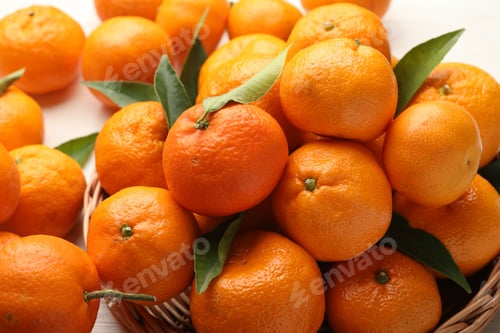Preview: Fresh tangerines and green leaves on table, closeup