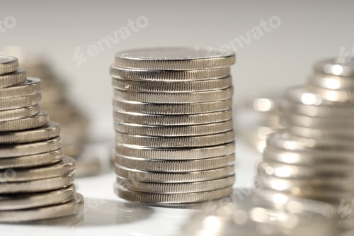 Preview: Many stacked coins on light background, closeup
