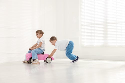 Preview: Little children with toy car at home, space for text