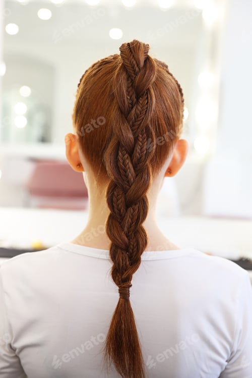 Preview: Teenage girl with beautiful braids in salon, back view