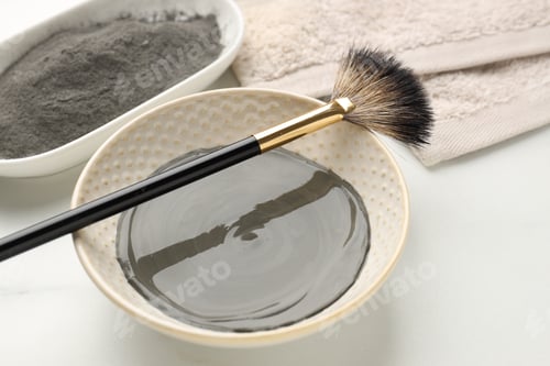 Preview: Clay powder, paste, brush and towel on white background, closeup