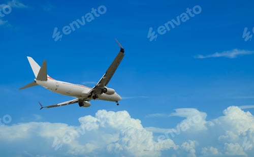 Preview: Airplane flying in beautiful blue sky with clouds